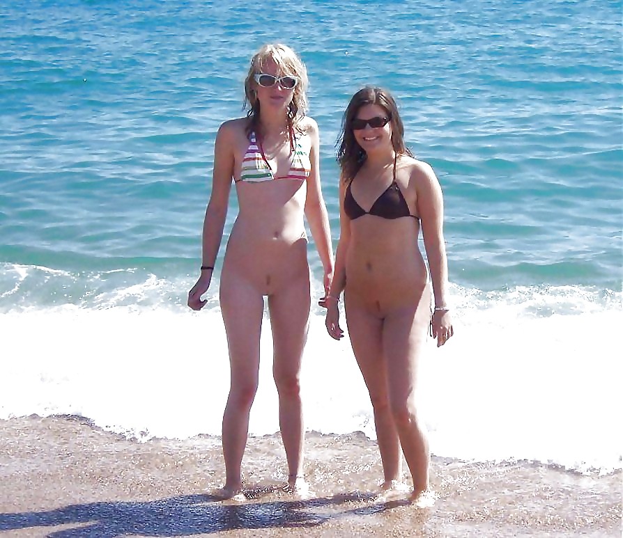 Naked twins on a beach