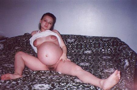 Little pregnant brunette on her bed
