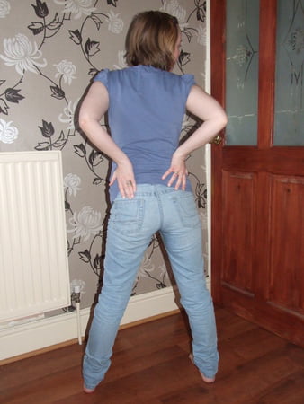 cute blonde posing in jeans and shirt         