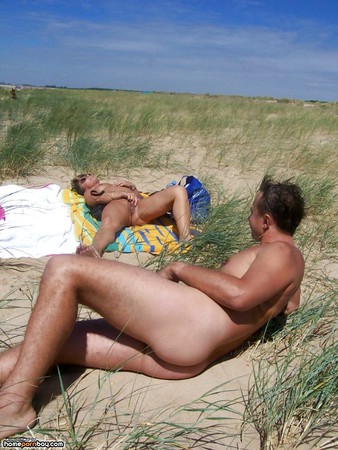 Spreading her legs on the beach