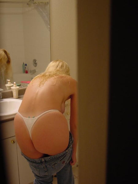 Mature Blonde dressing in mirror - 13 Photos 