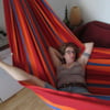 streching her legs in the hammock
