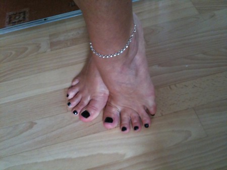 freshly painted black toe nails